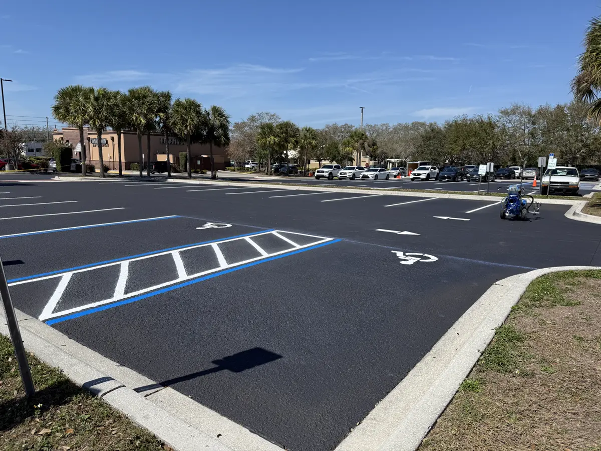 Panoramic view sealcoated parking lot with ADA compliant handicap stalls Palm Harbor Florida by Radiant Striping