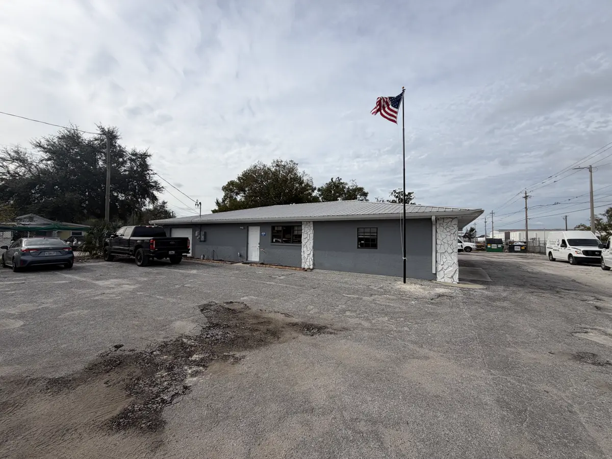 Commercial parking lot with multiple potholes and surface damage before asphalt repair by Radiant Striping Tampa