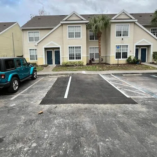 Commercial asphalt repair and parking lot patching with fresh striping at Tampa Bay residential property by Radiant Striping