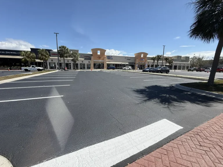 Commercial parking lot sealcoating completed with fresh black finish and crisp white striping Palm Harbor Florida by Radiant Striping