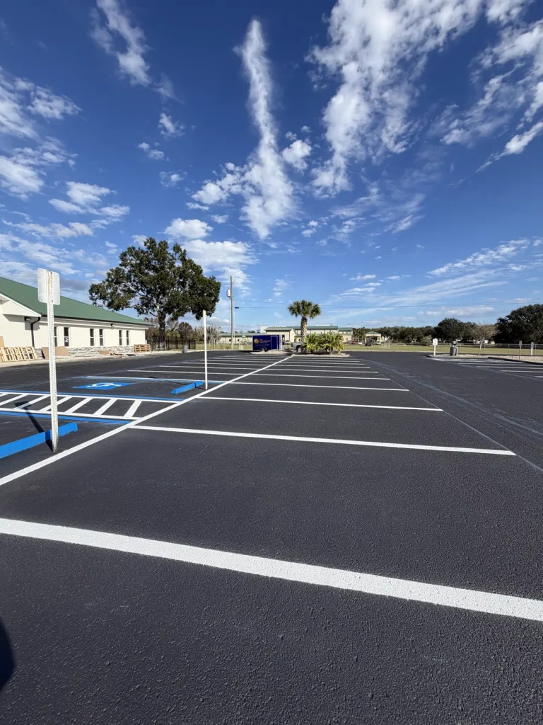 Fresh sealcoating and parking lot striping with ADA compliant handicap stalls commercial parking lot Tampa Bay by Radiant Striping