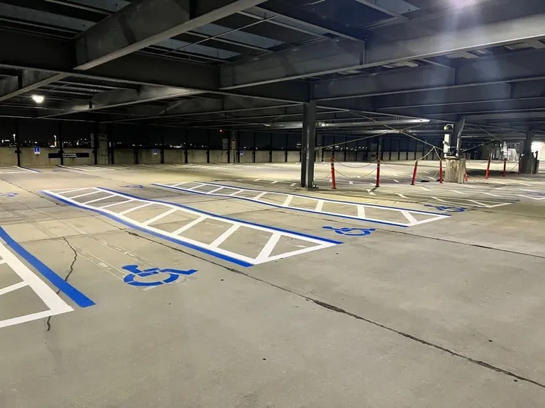 ADA handicap spaces with blue crosshatch markings in the James A. Haley Veterans Hospital parking garage in Tampa, Florida, completed by Radiant Striping
