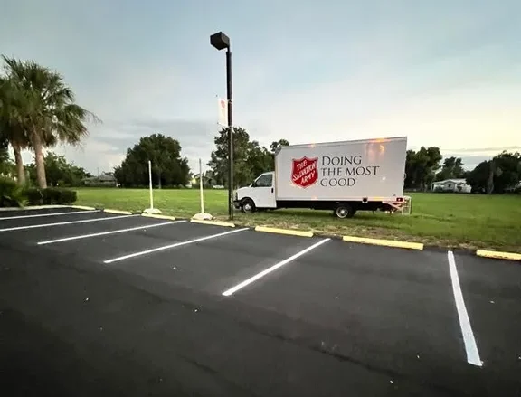 Fresh parking lot striping on sealed asphalt at The Salvation Army in Bradenton, Florida, completed by Radiant Striping