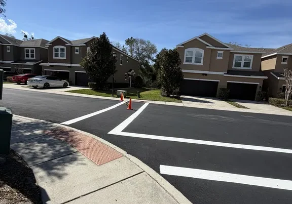 Fresh parking lot striping with crosswalk and stall lines at a townhome community in Riverview, Florida, completed by Radiant Striping