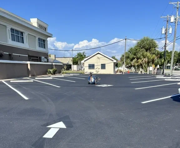 Completed parking lot striping with directional arrows and stalls at a commercial property in Clearwater, Florida, by Radiant Striping